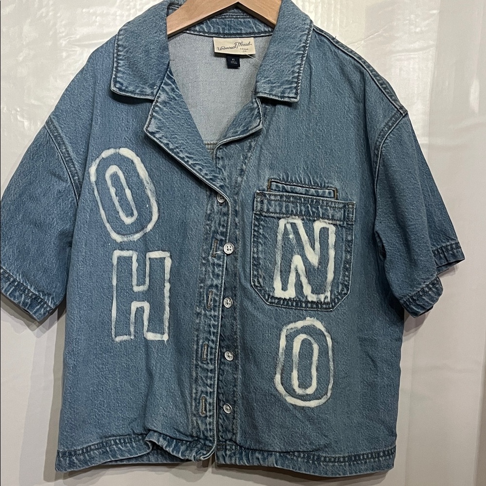 Upcycled Blue Denim Button-Up Shirt with White Lettering. Says XS